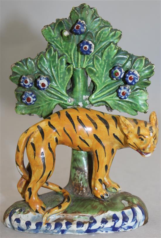 An early 19th century Staffordshire pearlware figure of an arched tiger, 13.5cm, damages